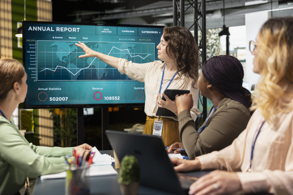 Cross-functional team reviewing shared data dashboard to align marketing, sales, and customer success insights