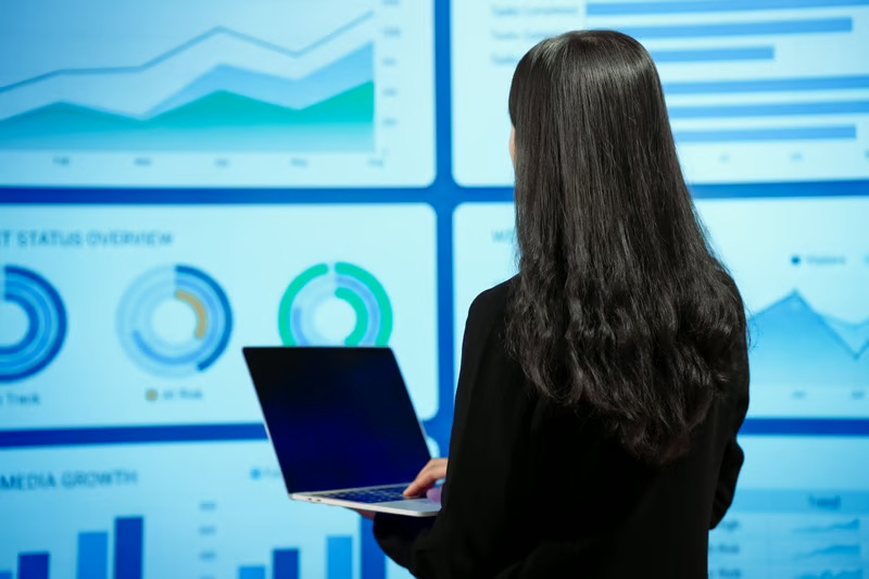Professional analyzing an AI-powered business intelligence dashboard to uncover hidden revenue opportunities and optimize GTM strategy through data-driven insights.