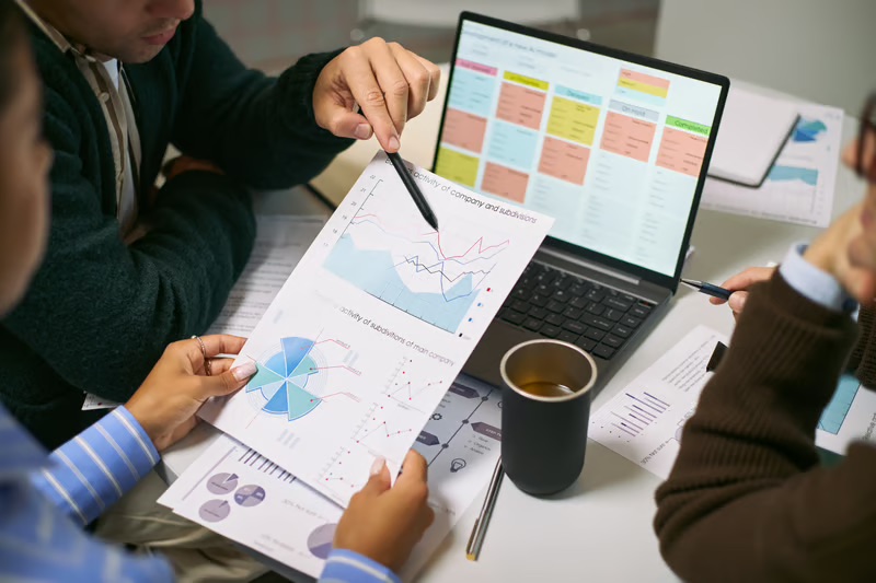 Team reviewing business growth data and performance charts for go-to-market strategy and revenue planning.